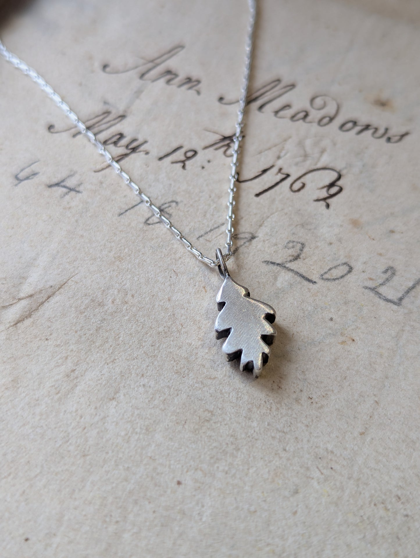 Small hand carved oak leaf pendant