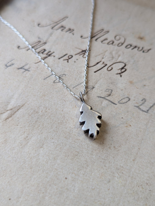 Small hand carved oak leaf pendant